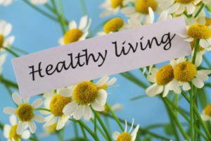 Healthy living card with chamomile flowers on blue background