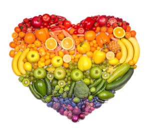 A rainbow heart of fruit and vegetables of vivid and beautiful colours